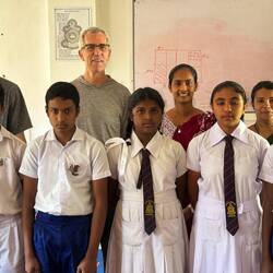 Peace Corps Volunteer Aiden and his students