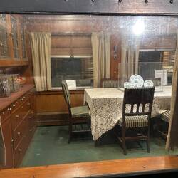 Private car dining area through a dirty window