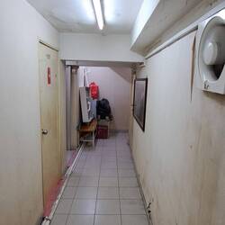 The hallway leading to the room.