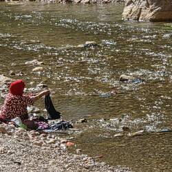 Washing her clothes among the tourists