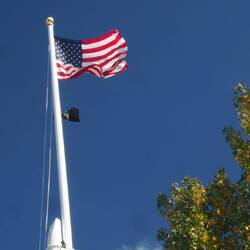 This flag pole is at 1 of 8 sites that Congress requires the flag to fly 24 hours a day.