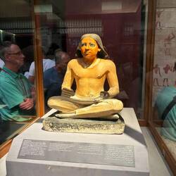 Astonishingly realistic statue of a 5th dynasty scribe, papyrus unfurled in his lap.