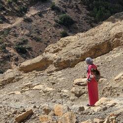 Mother carrying child down into the canyon