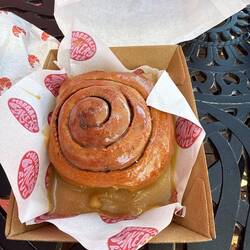 Delicious cinnamon bun with caramel sauce