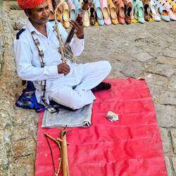Playing a traditional instrument used by shepherd's to call the sheep .