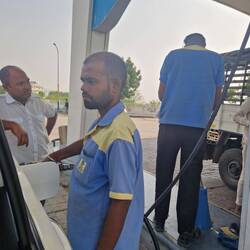 Petrol attendants serve petrol.to stop people filling up but not paying