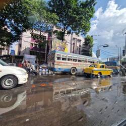 Bus and yellow taxi in Calcutta