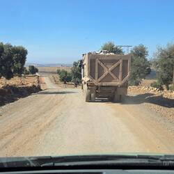 Truck drivers transporting immense quantities of rocks hacked out of the mountains to create roads