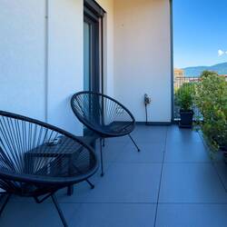 The outside space is a good-sized balcony with self-watering plants — Verbania, Italy.