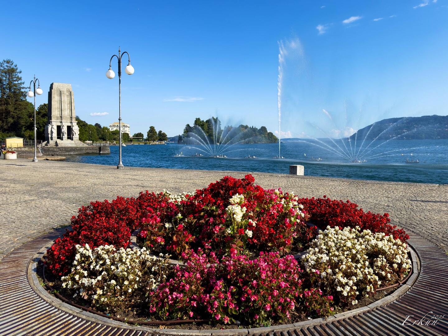 The lakefront promenade welcomes visitors with a dancing fountain — Pallanza, Italy.