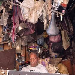 Taking a siesta in his "everything shop", bicycle saddles, water kettles and everything else