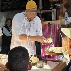 The sheep he just killed, being cut up weighed and sold in pieces