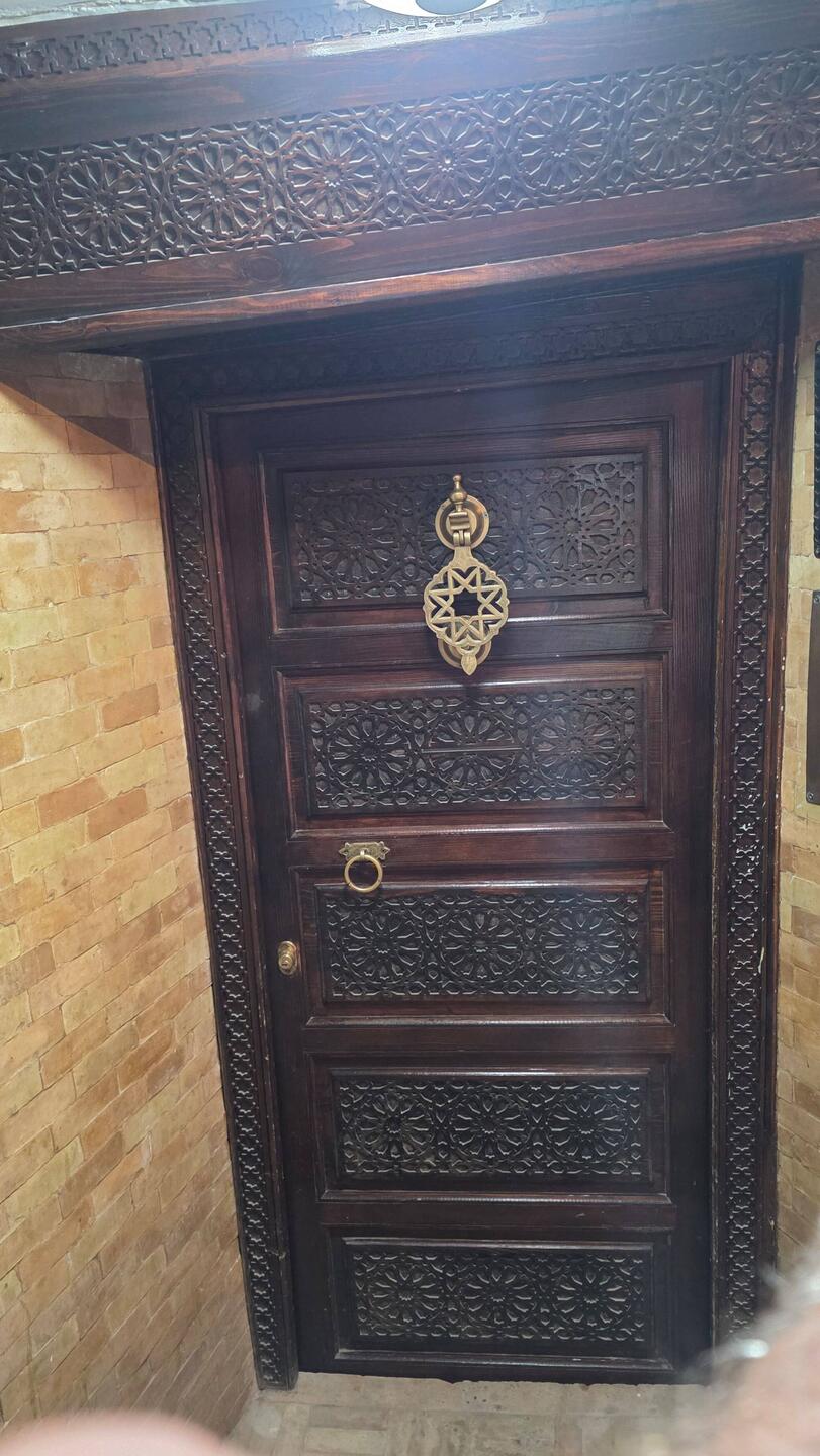 In a dark ally way, suddenly a decorated door!