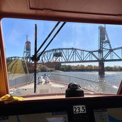 The railroad bridge is down... but no train do we see. We slip beneath, anyway.