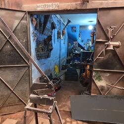 In a small yard a handfull of artisans, each doing something else