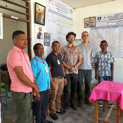 Peace Corps Volunteer with principal and staff at his school
