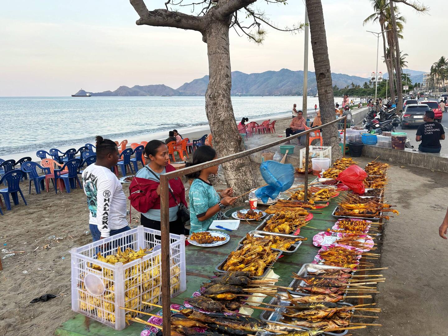 Vendors of fish and other cooked foods set up on the beach every afternoon/evening