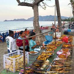 Vendors of fish and other cooked foods set up on the beach every afternoon/evening