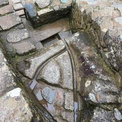 Water features that allow for settling out of sediment before the ceremonial fountains