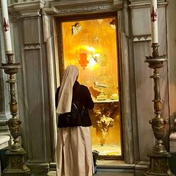 Nun in front of Mary Magdalene's left foot at Basilica of St John the Baptist