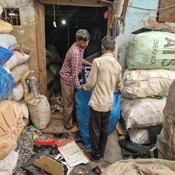 Hand sorting of used plastic a smelly job and lots of flies