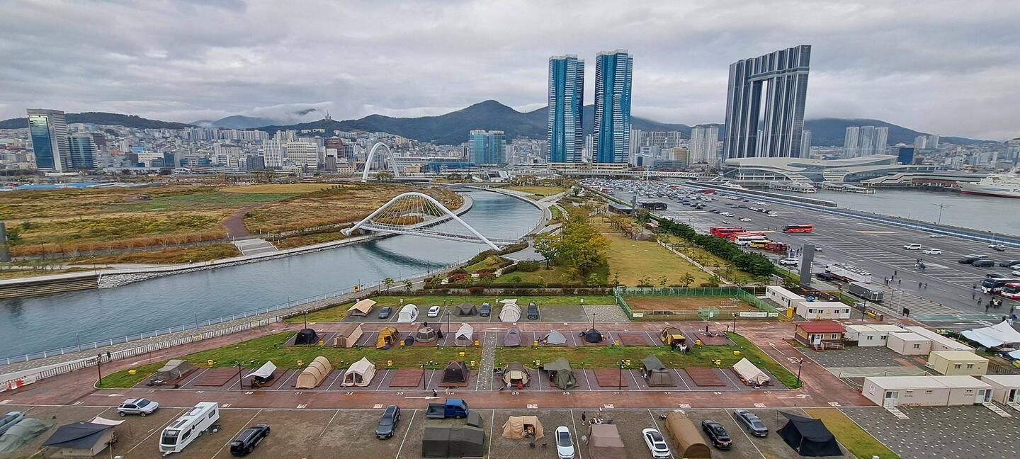 View from boat -- Campground (tents, fireplaces & all): foreground; Busan: background.