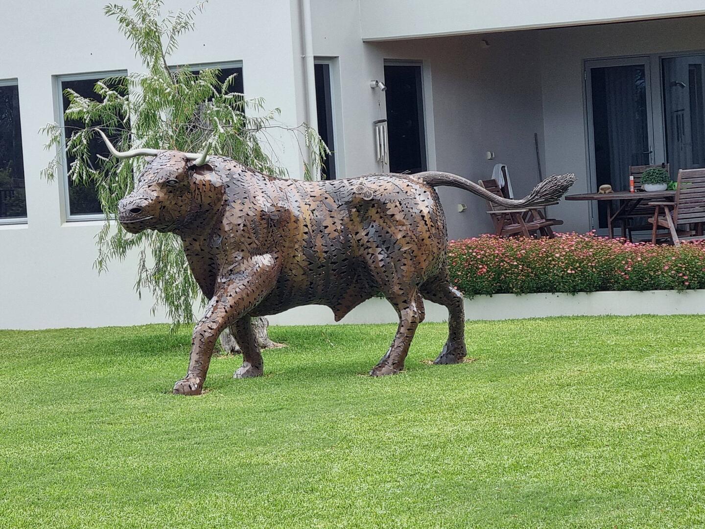 Full size bull stature in front yard.