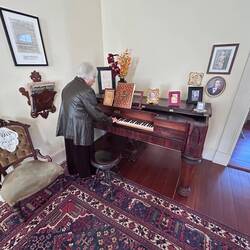 Anne plays a very old piano for us in the Raney Mansion