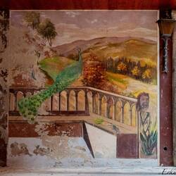 An open door on the street allows a glimpse of a fresco — Cannero Riviera, Italy.