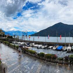 Piazza King Victor Emmanuel III and the marina in the rain — Cannobio, Italy.
