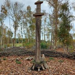 Wooden sword sculpture in the forest