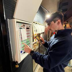 Ordering ramen out of the vending machine before going into shop