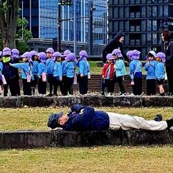 Forget the sleeping dude; look at all the little purple heads behind him!!!