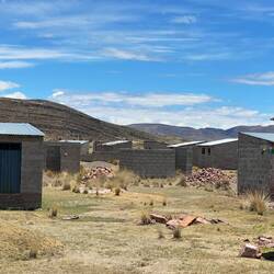 The area ia covered with groups of tiny concrete buildings - housing project? we don't know why