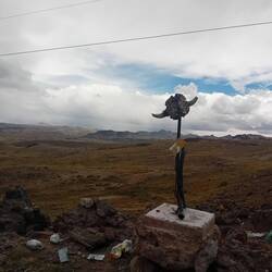 The pass: hail, wind, and a strange signpost.