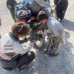 Checking tire pressure with his tiny hands instead of holding a pen in school.