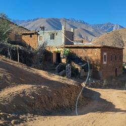 The road is so narrow that we have to fold in our mirrors to get through this village