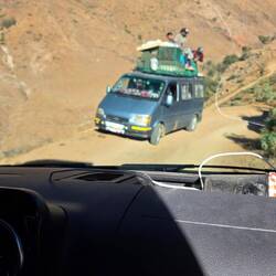 The track is hardly wider than 2m and this van suddenly appears. He backs up to the next curve!