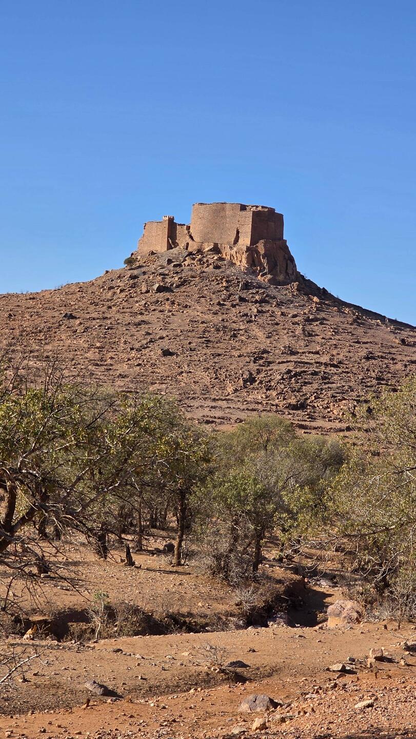 Agadir Tasguent made of stamped clay perches on a hill