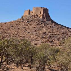 Agadir Tasguent made of stamped clay perches on a hill