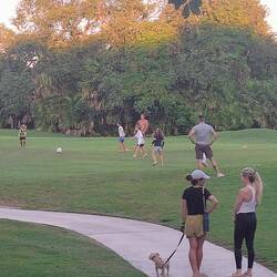 The golf course turns into soccer practice at dusk