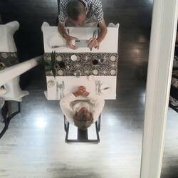 Dining under a mirrored ceiling