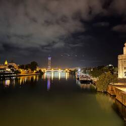 Looking along the Rio Guadalquivir towards the Puente de Triana and the modern Torre Sevilla