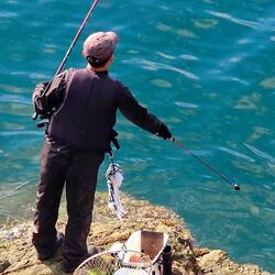 He 'chummed' the water by scooping up some pink stuff w/ a long scoop & tossing it into the water.