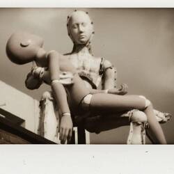 A statue on top of a building. Robotic Pieta?