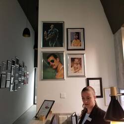 All the photos are of the band, and vinyl copies of albums on the credenza.