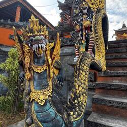 A naga guards the threshold to a temple