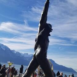 Lots of people around the Freddie Murcury statue on the lake front.