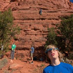 Holden playing with belay glasses while E heads up.