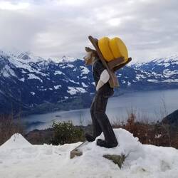 Cheese guy is just one of the wooden carvings in front of Lake Thun.